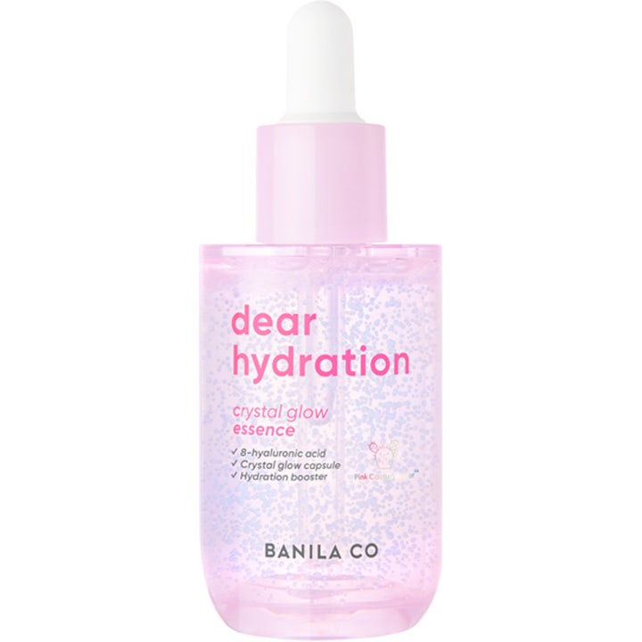 Banila Co Dear Hydration Crystal Glow Essence kosteuttava hoitoneste vaaleanpunaisessa pullossa liiloilla kapseleilla.
