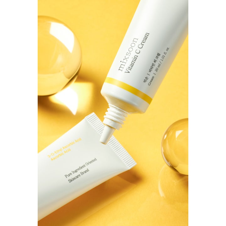 Mixsoon Vitamin C Cream 30 ml heleyttävä kasvovoide valkoisessa tuubissa keltaisella taustalla lasipallojen kera