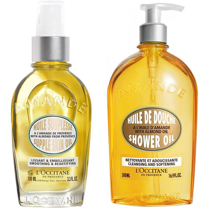 L'Occitane Amande Supple Skin Oil 100 ml ja Shower Oil 500 ml silottava vartalonhoito kultaisissa pumppupulloissa.