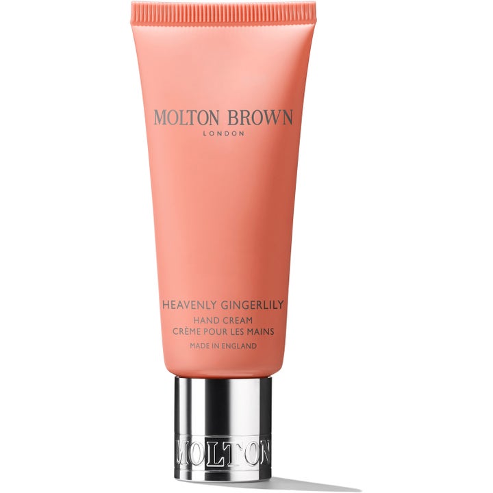 Molton Brown Heavenly Gingerlily Hand Cream kosteuttava käsivoide persikanvärisessä tuubissa hopeisella korkilla.
