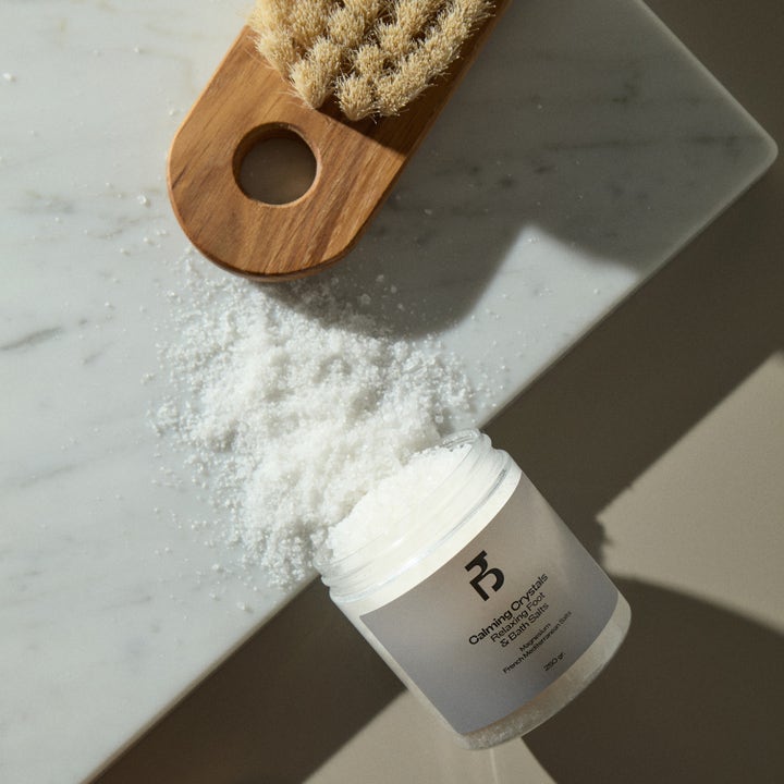 Bodyologist Calming Crystals Relaxing Foot & Bath Salts 250 g rentouttava kylpysuola marmorilla puisen harjan kera.