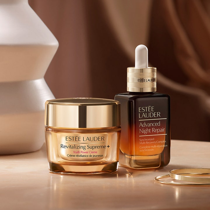 Estée Lauder Advanced Night Repair 75 ml seerumi ja Revitalizing Supreme+ kasvovoide kultaisissa lasipakkauksissa.