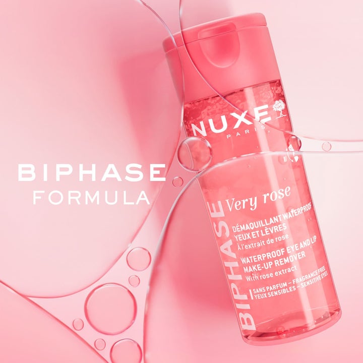 Nuxe Very Rose Biphase Makeup Remover 100 ml poistaa vedenkestävän meikin pinkissä pullossa vesipisaroiden ympäröimänä