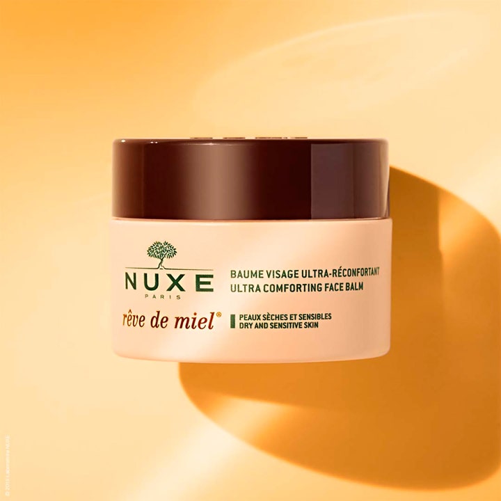 Nuxe Rêve de Miel 50 ml rauhoittava kasvovoide vaaleassa purkissa, jossa on ruskea korkki.