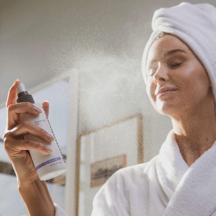 Dermalogica UltraCalming Mist 177 ml rauhoittava kasvosuihke nainen suihkuttaa hienojakoista sumua kasvoilleen
