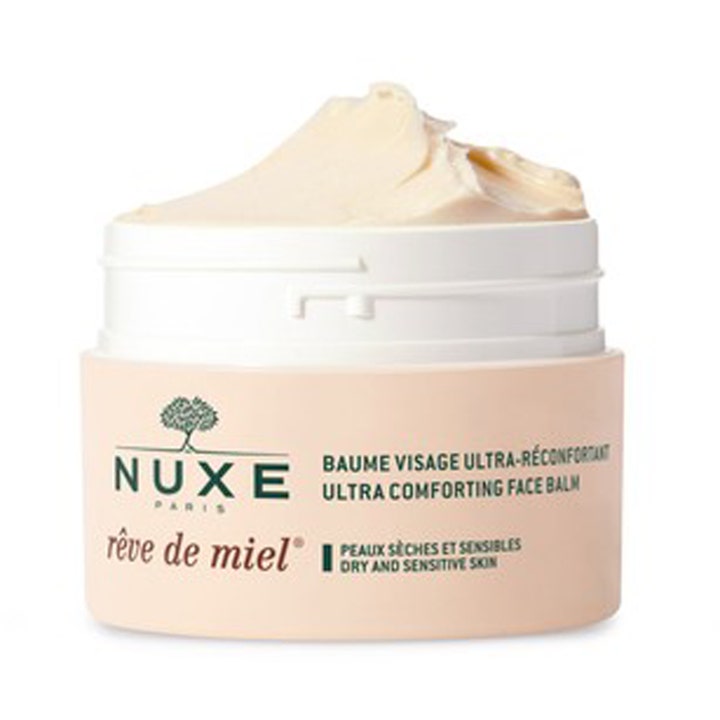 Nuxe Rêve de Miel 50 ml ravitseva kasvovoide on täyteläinen voide beigeen sävyisessä avatussa purkissa.
