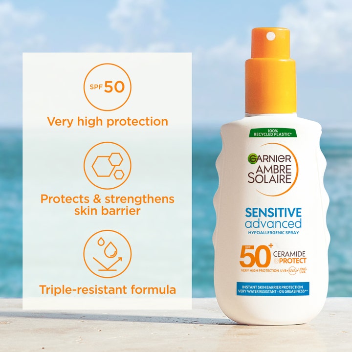 Garnier Ambre Solaire Sensitive Advanced 150 ml aurinkosuojasuihke SPF 50 ja Ceramide Protect rantamaisemassa.
