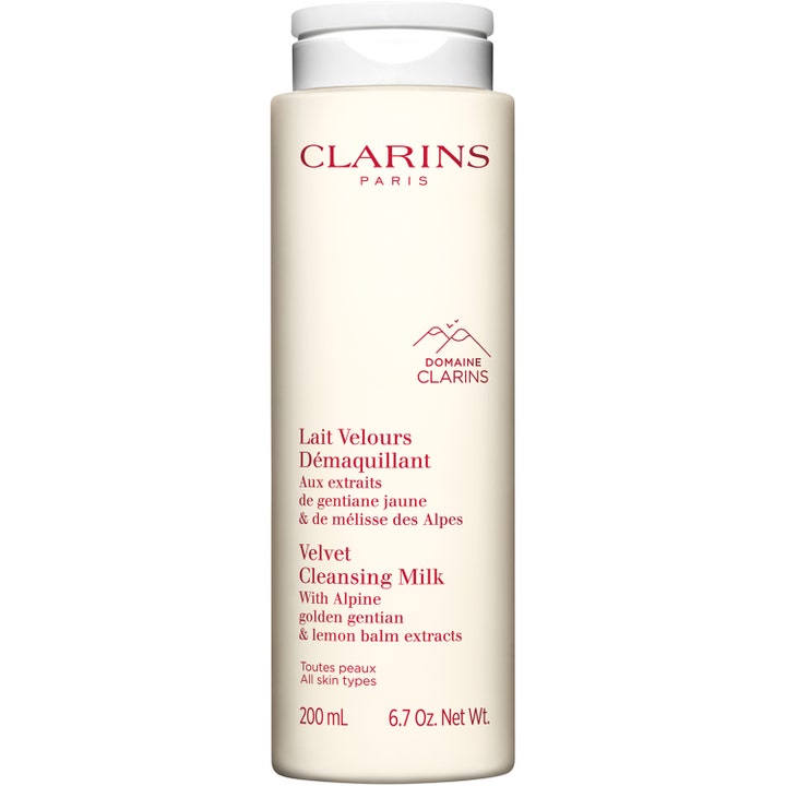 Clarins Velvet Cleansing Milk 200 ml puhdistusmaito pehmentää ihoa kermanvärisessä pullossa valkoisella korkilla.