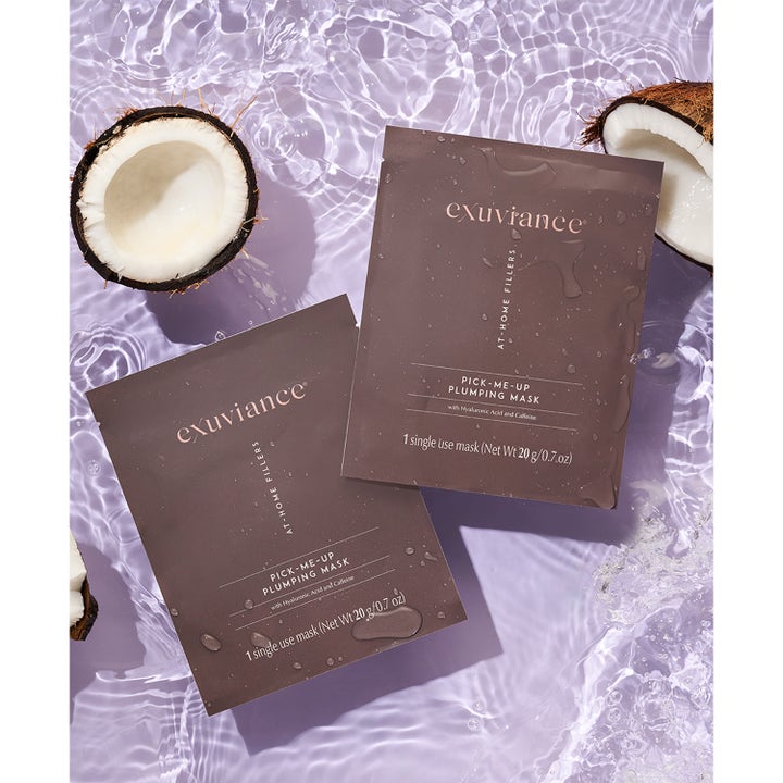 Exuviance Pick-Me-Up Plumping Mask 20 g täyteläistävä kangasnaamio ruskeissa pusseissa veden ja kookoksen ympäröimänä.