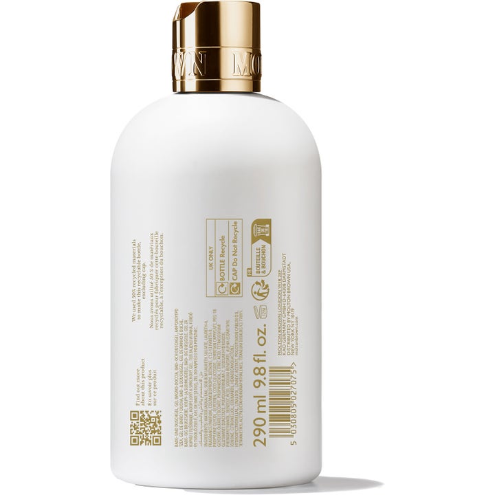 Molton Brown Milk Musk 300 ml suihkugeeli valkoisessa pullossa, jossa on kultainen korkki ja ainesosatiedot.