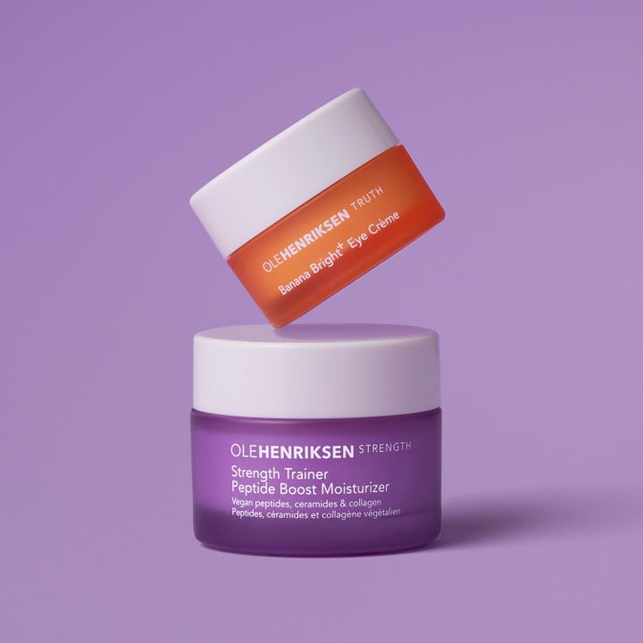 Ole Henriksen Strength Trainer 15 ml ja Banana Bright 7 ml ihonhoitosetti, oranssi ja liila purkki päällekkäin.