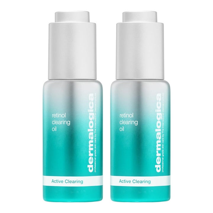 Dermalogica Retinol Clearing Oil kirkastava kasvoöljy kaksi turkoosia liukuvärjättyä pulloa hopeisilla korkeilla.