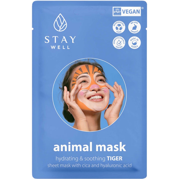 Stay Well Animal Mask Tiger rauhoittava kangasnaamio sinisessä pakkauksessa, jossa nainen käyttää oranssia tiikerimaskia.