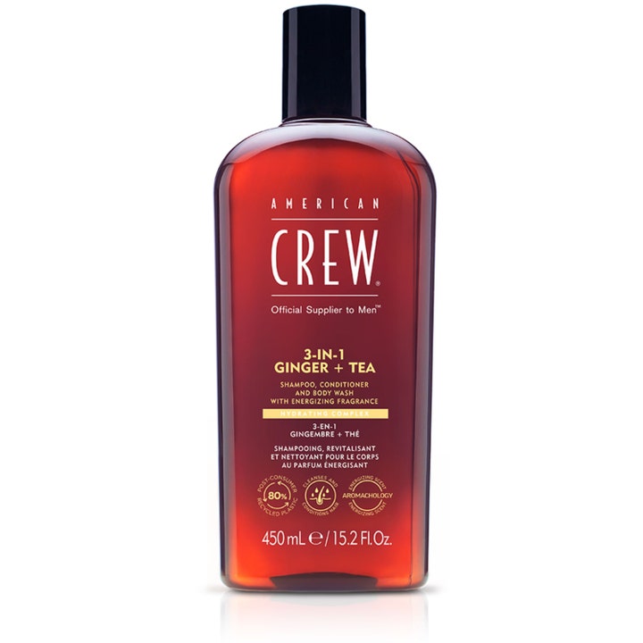 American Crew 3-in-1 Ginger + Tea 450 ml kosteuttava monitoimituote meripihkanvärisessä pullossa mustalla korkilla.