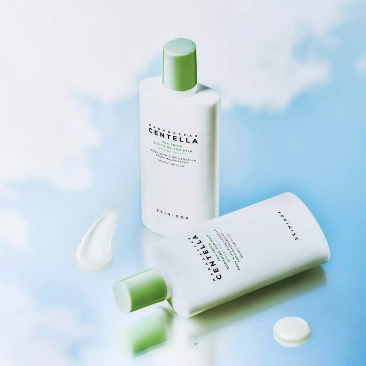SKIN1004 Madagascar Centella Tea-Trica Soothing Sun Milk 50 ml SPF 50+ rauhoittava aurinkovoide ja kermainen näyte.
