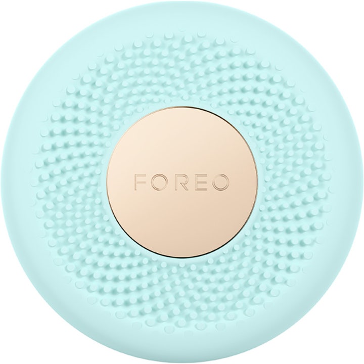 Foreo UFO 2 Mint kasvonaamio-laite elvyttää ihoa. Pyöreä mintunvihreä silikonilaite kultaisella logolla.