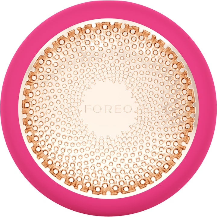 Foreo UFO kasvolaite syväkosteuttavaan kasvohoitoon on pyöreä pinkki laite jossa on kultainen metallilevy.
