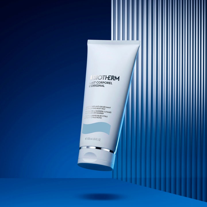 Biotherm Lait Corporel 200 ml kosteuttava vartalovoide valkoisessa tuubissa sinistä taustaa vasten.